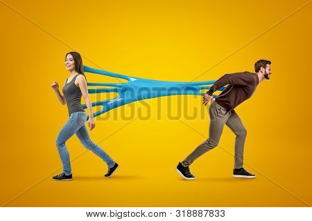 Young Brunette Girl Wearing Casual Jeans And T-shirt Stuck To Young Man In Casual Clothes With Blue 