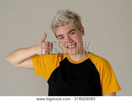 Portrait Of Good Looking Young Trans Teenager Male Showing Thumbs Up Sign Feeling Cheerful Happy And