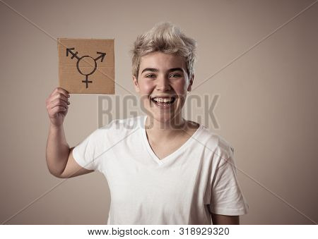 Good Looking Happy And Proud Trans Teenager Holding The Symbol Of The Transgender Drawn On A Cardboa