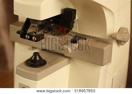 Optical Dispensing Epuipment Being Grinding Prescription Lenses In Australia