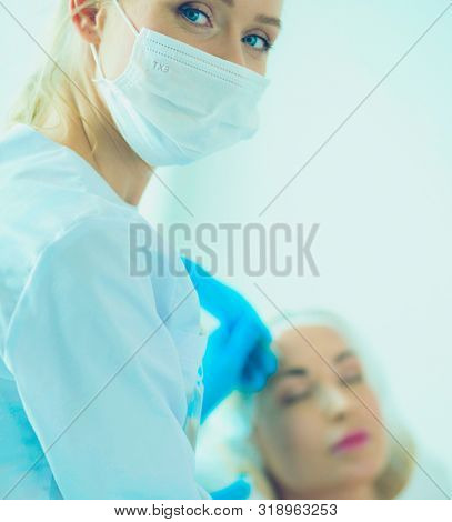Portrait of female standing near open fridge full of healthy food, vegetables and fruits. Portrait of female