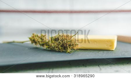 Preparing To Cooking Cake With Cannabis Butter. Concept Of Using Marijuana In Food Industry.