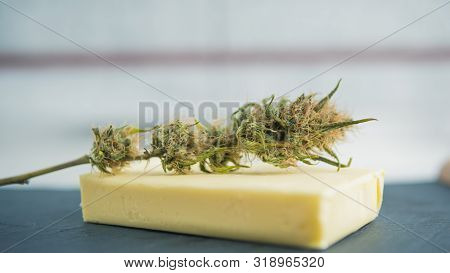 Preparing To Cooking Cake With Cannabis Butter. Concept Of Using Marijuana In Food Industry.