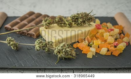 Preparing To Cooking Cake With Cannabis Butter. Concept Of Using Marijuana In Food Industry.