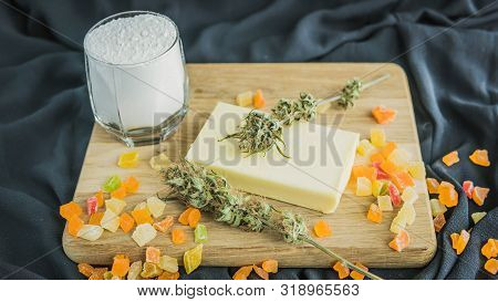 Preparing To Cooking Cake With Cannabis Butter. Concept Of Using Marijuana In Food Industry.