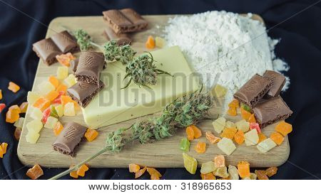 Preparing To Cooking Cake With Cannabis Butter. Concept Of Using Marijuana In Food Industry.