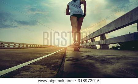 Female Runners Exercise By Running In The Morning Or Evening. The Concept Of Maintaining Good Health