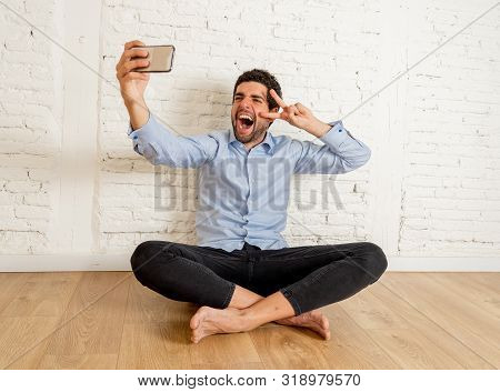 Cheerful Young Hipster New Owner Taking Selfie With Smart Mobile Phone In His New Empty Flat Happy W