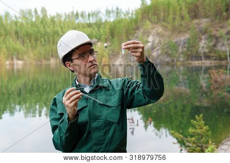 Industrial Ecologist Or Hydrologist Visually Evaluates The Response Of A Water Sample From Lake At T