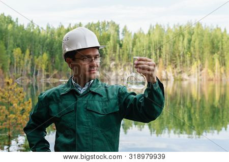 Industrial Ecologist Or Hydrologist Visually Evaluates The Response Of A Water Sample From Lake At T