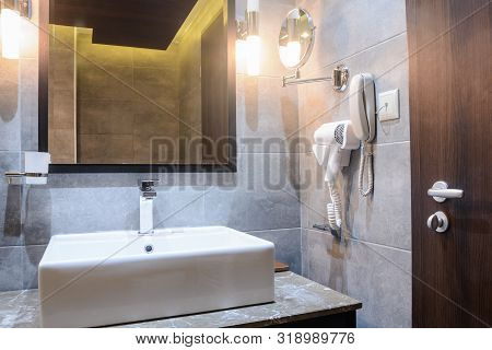 Washbasin With Mirrow In The Hotel Bathroom
