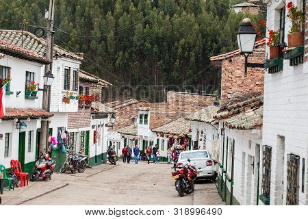 Mongui, Colombia - August, 2019: Tourists And Locals At The Beautiful Streets Of The Small Town Of M