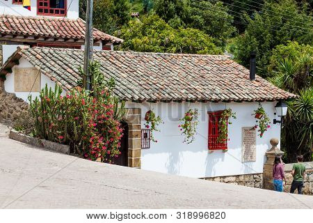 Mongui, Colombia - August, 2019: Tourists At The Beautiful Streets Of The Small Town Of Mongui In Co