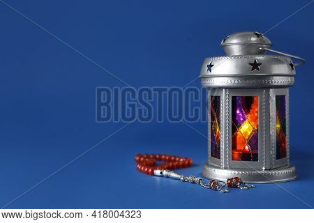 Decorative Arabic Lantern And Misbaha On Blue Background. Space For Text