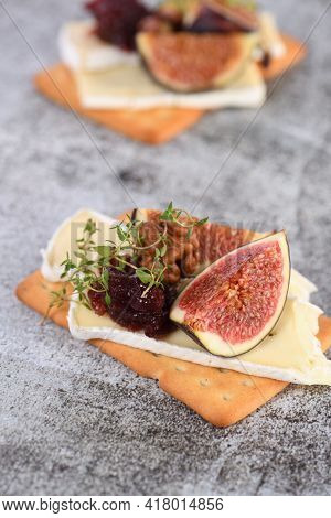 Cracker With A Slice Of Camembert, Jam, Figs And Nuts.
A Great Snack Idea For A Holiday, Picnic Or P