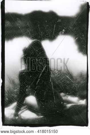 Abstraction: A Naked Slender Girl Sits By The Water. Attention! The Image Contains Grain And Other A