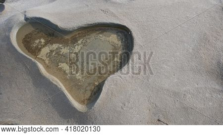 Deepening Relief In The Form Of Craters On Limestone And Rock Near The Sea. In The Form Of A Heart.