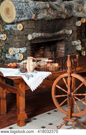Variety Of Food Ingredients For Bread Baking Along With Retro Spinning Wheel Placed On Table