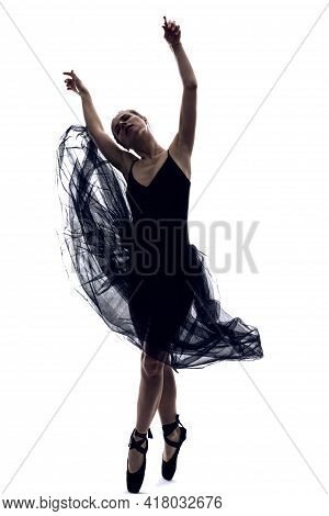 Professional Female Ballet Dancer In Body Suit And Flying Black Dress Posing In Dance In Various Pos