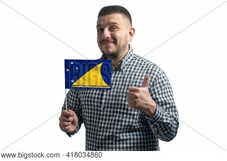White Guy Holding A Flag Of Tokelau And Shows The Class By Hand Isolated On A White Background. Like