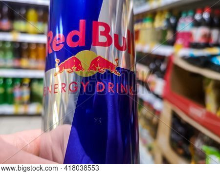 Close-up Of A Can Of Energy Drink With Caffeine And Taurine Red Bull In Hand Against The Background 