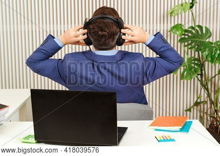 Successful Businessman Resting At His Office. Business Man Finished Big Project. Back View Office Wo
