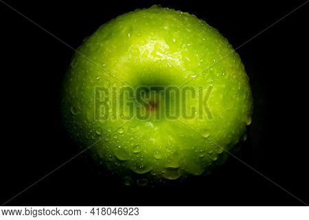 Fresh Green Apple With Water Drops Over Black Background
