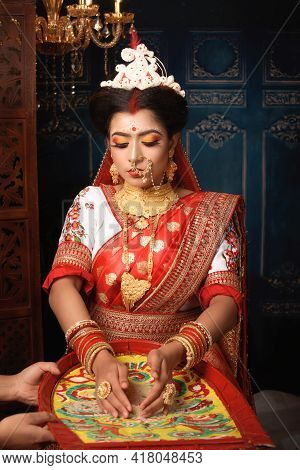 Portrait Of Beautiful Indian Woman Wearing Traditional Indian Saree, Gold Jewellery And Bangles Thro