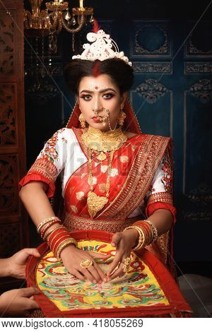 Portrait Of Beautiful Indian Woman Wearing Traditional Indian Saree, Gold Jewellery And Bangles Thro