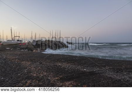 Boats In Vlichada Harbor On Santorini Island In Greece In The Morning At Sunrise. The Background Is 