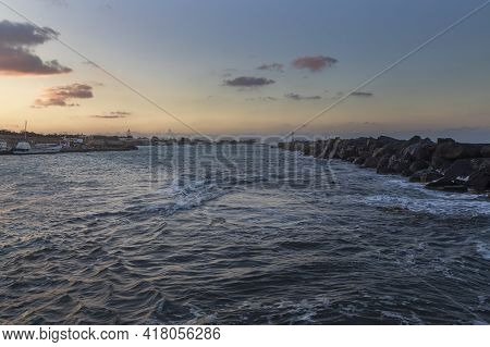 Boats In Vlichada Harbor On Santorini Island In Greece In The Morning At Sunrise. The Background Is 
