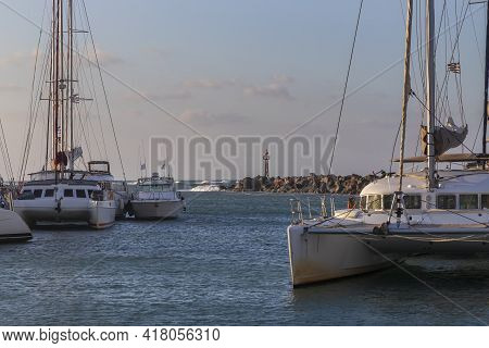 Boats In Vlichada Harbor On Santorini Island In Greece In The Morning At Sunrise. The Background Is 