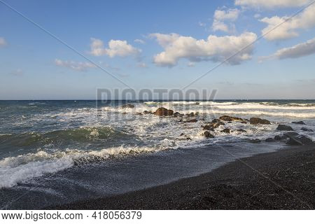Beautiful Black Beach With Coast And Sea In Vlichada With Blue Sky Background With White Clouds And 