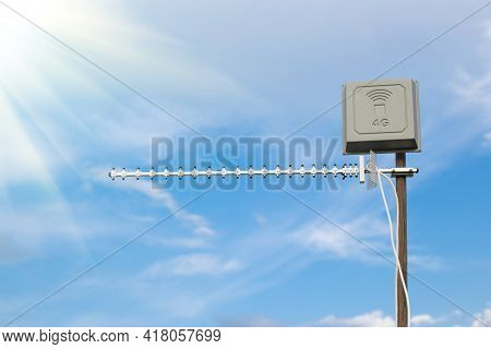 Antenna For 4g And 5g Mobile Internet On Blue Sky Background With Sunshine.