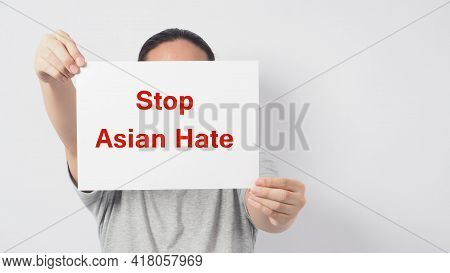 Stop Asian Hate In Red Color Write In White Board Paper.asian Man Holding Paper On White Background.