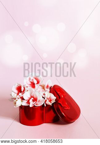 Heart Shape Gift Box And Bouquet On Pink Background.