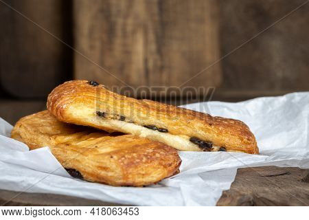 French Pastries, Tasty Chocolate Puff Bakery On White Paper And Wooden Brown Background