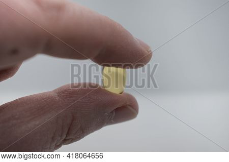 Man's Hand Holding Fish Oil Capsules.fish Oils Capsules As A Dietary Supplement Containg Omega-3 For