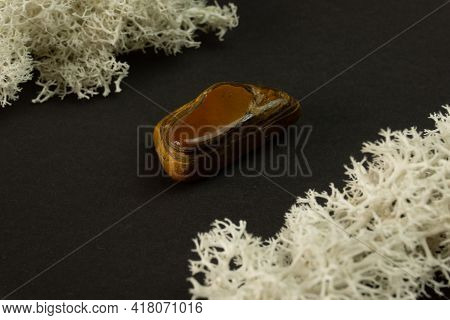 Tiger's Eye Stone From Republic Of South Africa Rsa. Natural Mineral Stone On Black Background. Mine