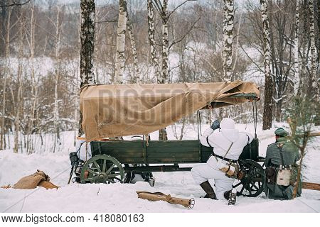 Hidden Re-enactor Dressed As German Wehrmacht Infantry Soldier In World War Ii Soldiers Sitting In A