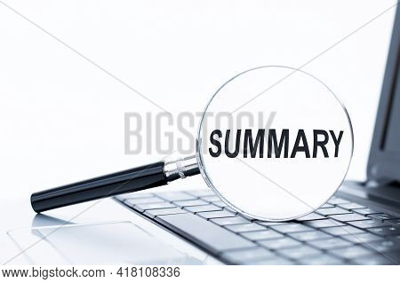 The Word Summary On Magnifying Glass, Which Is On The Laptop Keyboard. Business Concept.