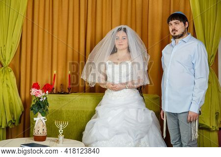 A Jewish Bride With A Veiled Face Of The Badeken Tradition And A Groom In A Synagogue Stand In Front