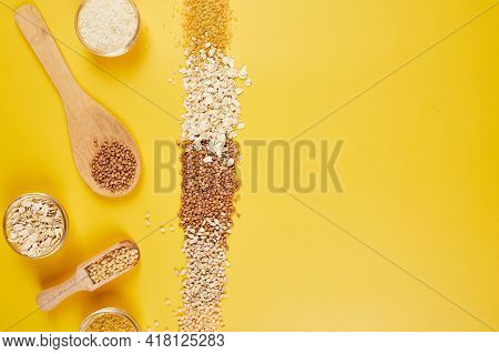 Flat Lay Of Set Of Heap Various Grains And Cereals On Yellow Background