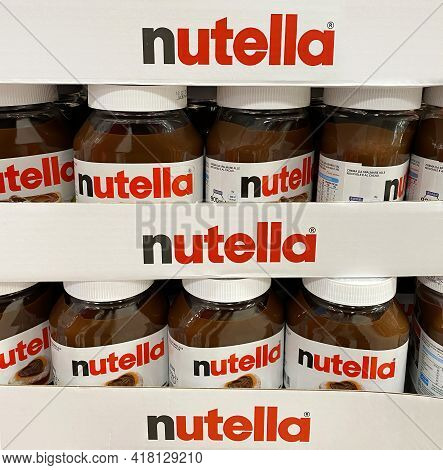 Bologna - Italy - April 21, 2021: Nutella Hazelnut Spread Jars In Shelf Of An Italian Supermarket. N