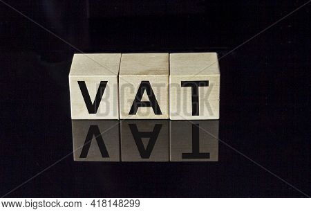 Vat, Value Added Tax Concept By Wooden Block Cube With Alphabet Building The Word Vat In Center On D