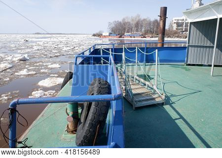 Metal Pier On The River With A Covered Shed For People Waiting For The Ship. Ice Drift On The River.