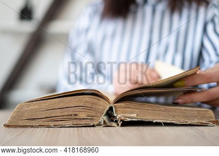 Learn More About The Concept Of The Book. Young Woman Reads A Book While Relaxing, Hands Hold A Book