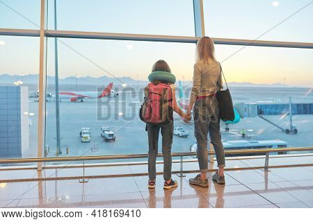 Airport Passengers Family Mother And Daughter Child Looking At Planes In Panoramic Window