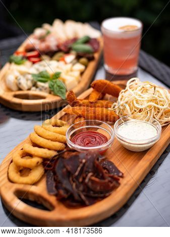 Assorted Beer Snacks, Fast Food. Bbq Wings, Onion Rings, Cheese, Meats With Cold Summer Coctail