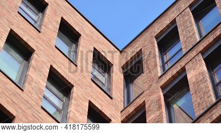 Modern Brick And Glass Facade Of The Office Building.  A Contrasting Combination Of Sky And Brick Te